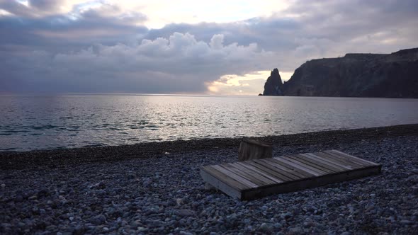 Empty Wooden Deckchair on the Beach