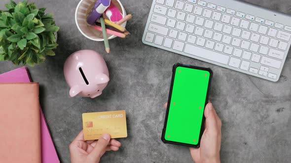 Top view, Woman customer hands holding credit card and smartphone