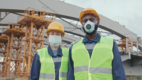 Multi-Ethnic Construction Workers in Face Masks Posing