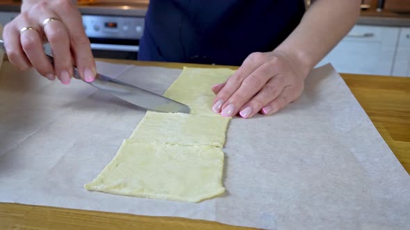Cook Hands Cut the Dough Into Small Pieces with a Knife