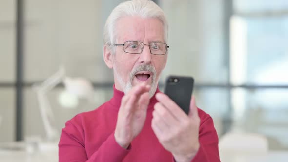 Old Man Celebrating on Smartphone