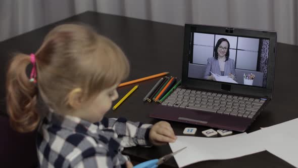 Girl Distance Education Lesson with Woman Teacher, Using Digital Laptop at Home