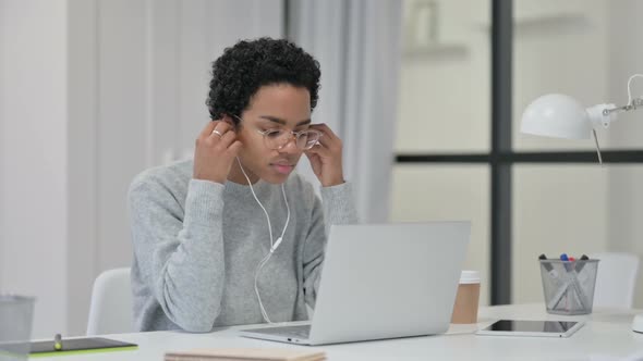 African Woman Meditating Listening to Music on Laptop