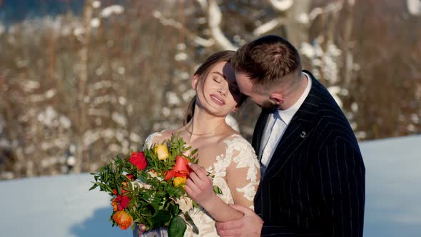 the Bride and Groom on the Background of the Mountains