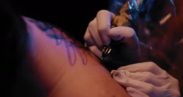 A person getting a tattoo in a professional studio. BMPCC 4K