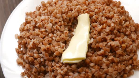 Buckwheat Breakfast Healthy Foot with Butter on a White Plate