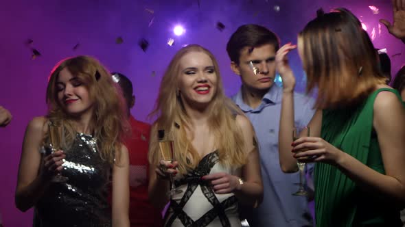 Young Girls Dance and Chat with Glass of Champagne