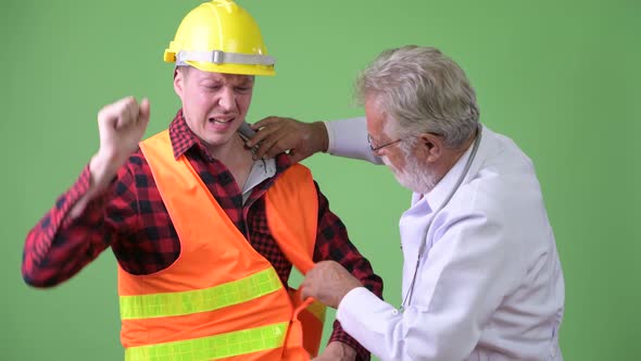 Senior Bearded Man Doctor Consulting Construction Worker Man Patient