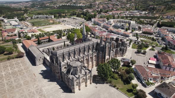 Cityscape of Batalha and majestic Unesco monastery building, aerial orbit view