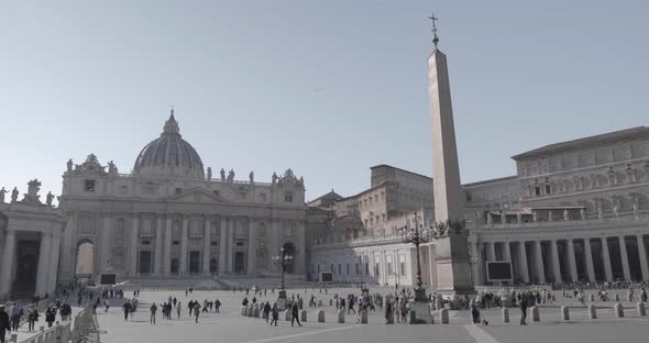 People walking in front of the Obelisk in San Pietro Square in a sunny day