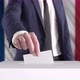 Voting. Man Putting a Ballot into a Voting Box with French Flag on Background. - VideoHive Item for Sale