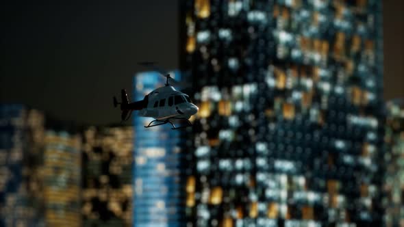 Slow Motion Helicopter Near Skyscrapers at Night