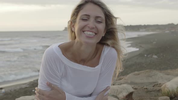 Young woman on the beach during a windy day