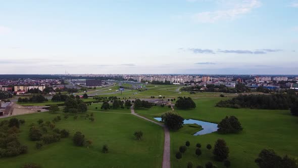 Flying towards Šilainiai district of Kaunas city in beautiful drone aerial shot with highway anding