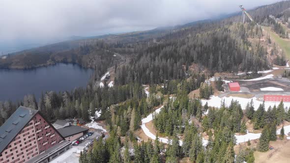 Aerial View of Strbske Pleso, Slovakia. Mountain Lake in Clouds and Snowy Tatras Mountains