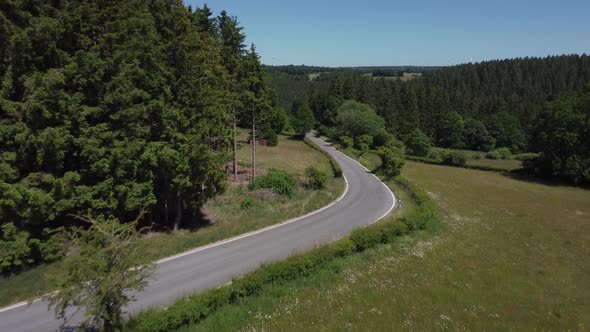 Road in nature reserve Eifel in Germany near Kalterherberg, hills and forest