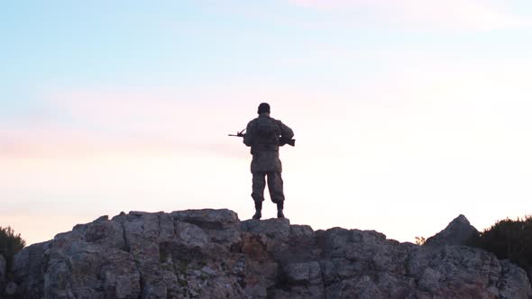 Soldier In The Morning Holds Guard With His Rifle