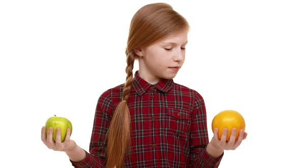 Young Attractive Caucasian Girl with Plait of Hair Balancing Orange and Apple
