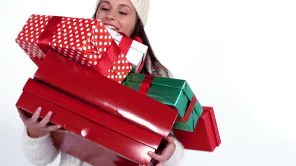 Festive woman carrying pile of gifts