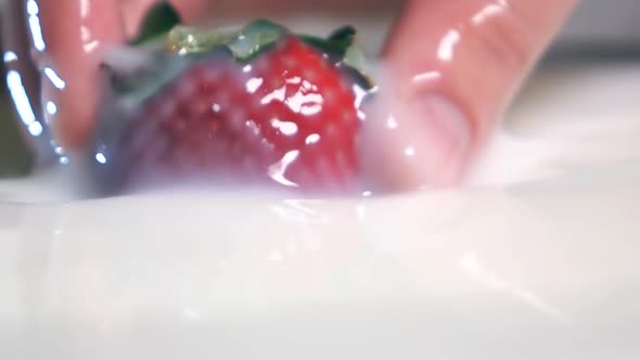 Pulling Strawberry From Milk