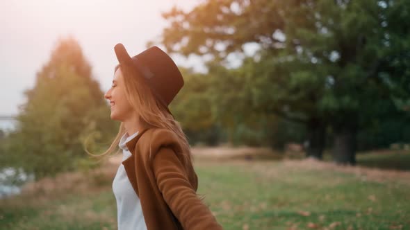 The Happy Young Woman Is Dancing and Jumping in the Forest