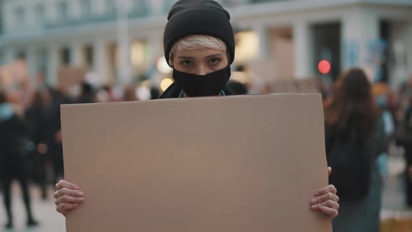 Protest and Demonstrations. Rebellious Woman with Face Mask Striking 