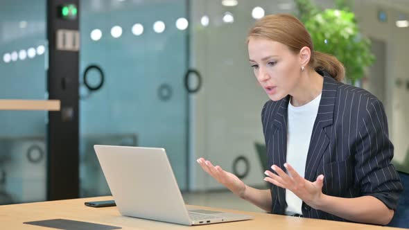 Upset Young Businesswoman Having Loss on Laptop in Office