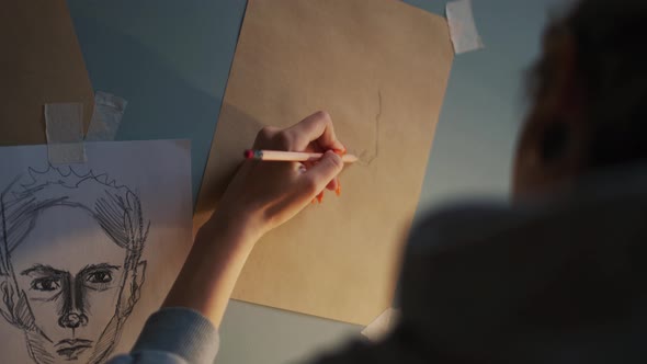 Close-up view of female hands drawing horse on paper