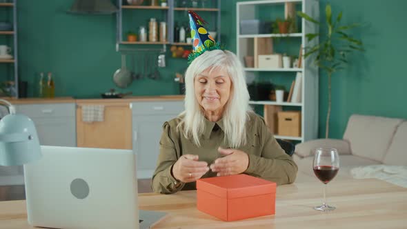Happy Elderly Woman Celebrating Birthday Online