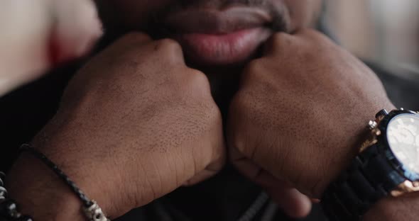 Brutal Confident African Man Sitting at the Table Leaning Head on Hands