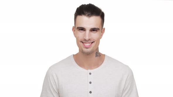 Headshot of Attractive Stylish Tattooed Man with Bristle Looking on Camera Smiling with Teeth