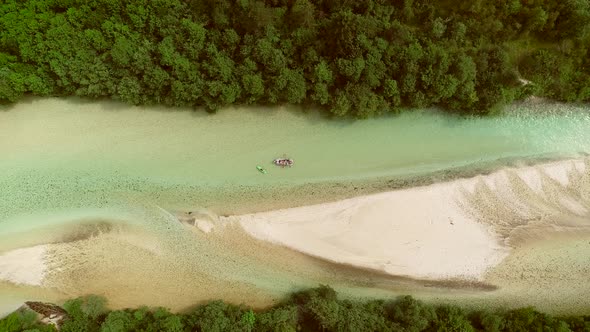 Aerial view of whitewater kayaker paddling on the Soca river, Slovenia.