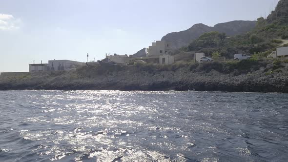 Sicilian Levanzo island and seafront scenic cemetery as seen from boat sailing, Sicily in Italy