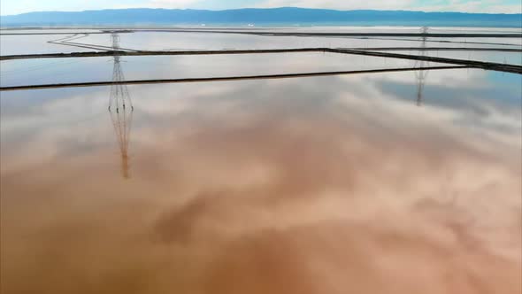 Aerial of Power Lines Over Evaporation Ponds