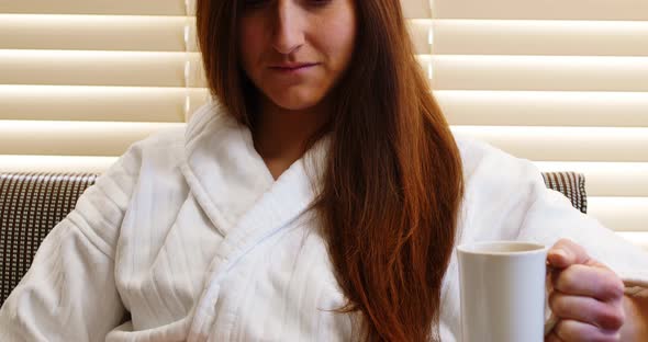 Woman having coffee in hotel