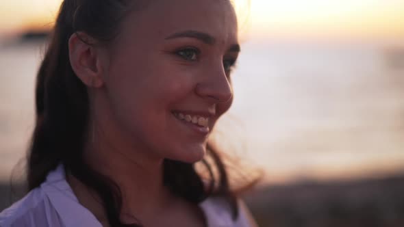 Headshot of Confident Beautiful Smiling Young Woman Looking Away Standing in Darkness Outdoors on