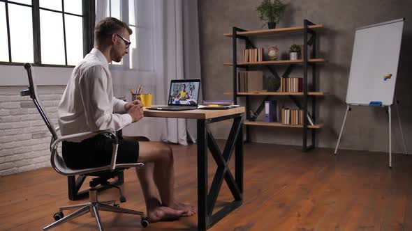 Barefoot Man in Shorts at Online Business Meeting