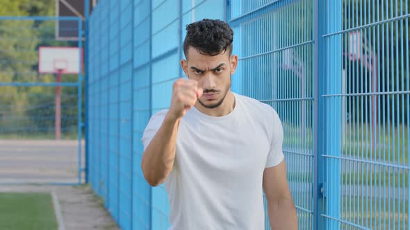 Angry Excited Football Fan Young Arabic Hispanic Male Athlete Waving Hand with Clenched Fist Middle