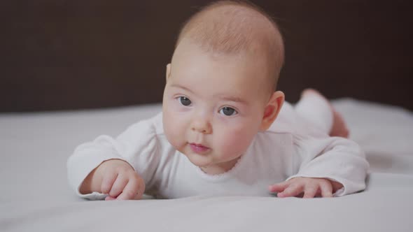 Close Up Slow Motion of Lovely Little Baby Girl Smile Indoor Portrait of Infant Smile.