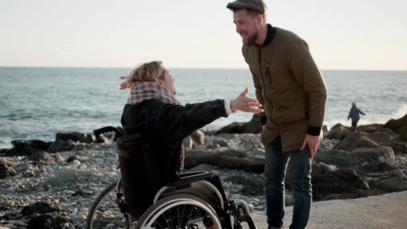 Man Cheering Up Disabled Woman He Loves