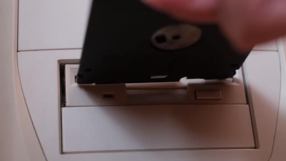 Closeup of Installing Floppy Disk in Retro Computer