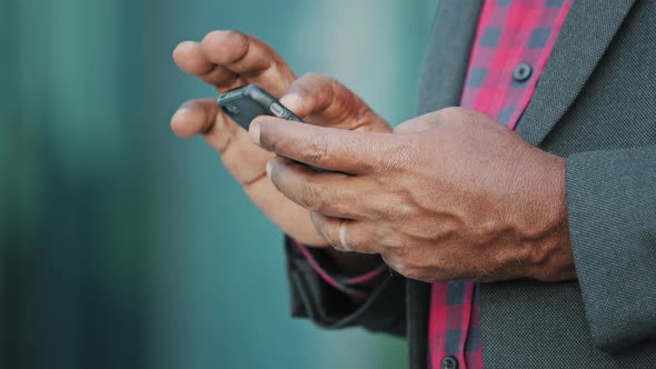 Closeup Male Hands Typing Old Elderly Black Person Texting Message Shopping Online on Cellphone