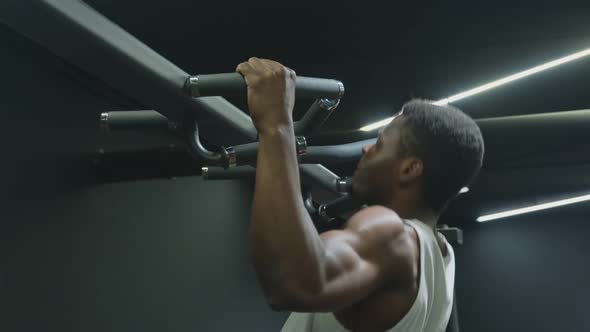 Handsome Afro American Muscular Man Doing Pull Ups on Horizontal Bar