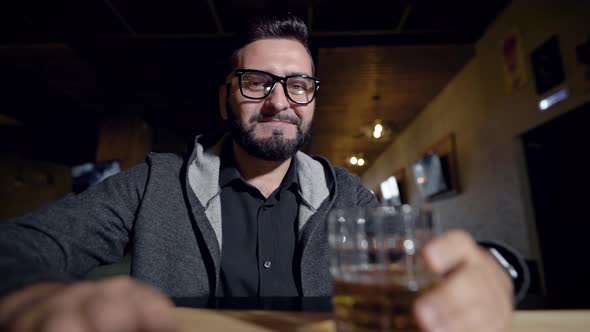 Man Is Sitting Alone in a Restaurant and Drinking Scotch