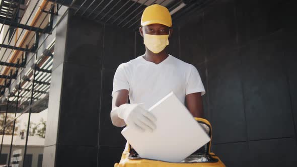 African American Delivery Worker in Yellow Cap and White Tshirt Uniform Mask