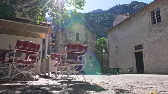 Kotor, Montenegro. Cafe on Streets of Old Town Lit By Bright Sun Beams. UHD