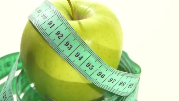 Green Apple with Measuring Tape on White, Rotation, Reflection