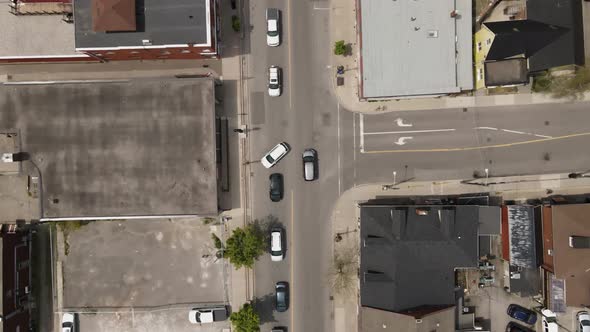 Aerial flyover downtown of Grimsby in Canada with traffic on road during rush hour time and sunlight