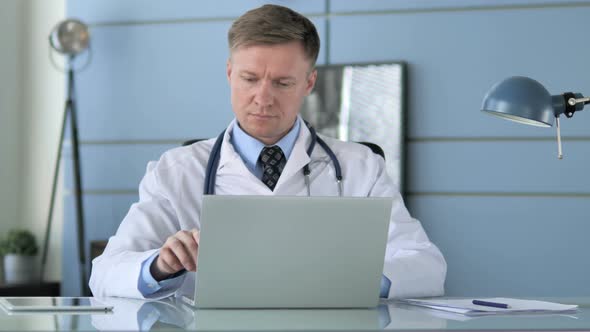 Doctor Working on Laptop