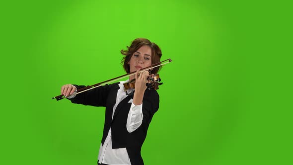 Girl in the Jacket Plays the Violin . Green Screen